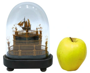 À peine plus haute qu’une pomme, maquette de ponton, en buis, sur un autel à trois niveaux. Présence originale de cinq marins à bord,